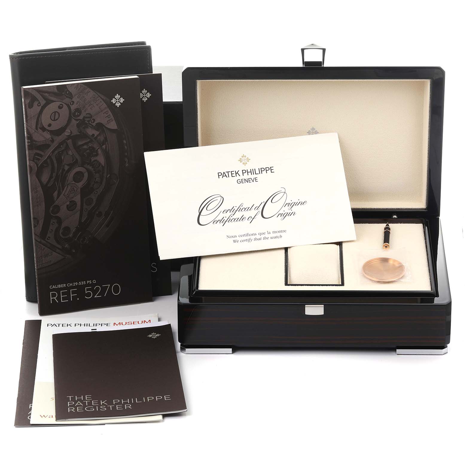 The image shows the Patek Philippe Complications 5270R-001 Men's Rose Gold Silver Dial 5270R-001 Men's Rose Gold Silver Dial model packaging, certificates, and a watch accessory in an open box.