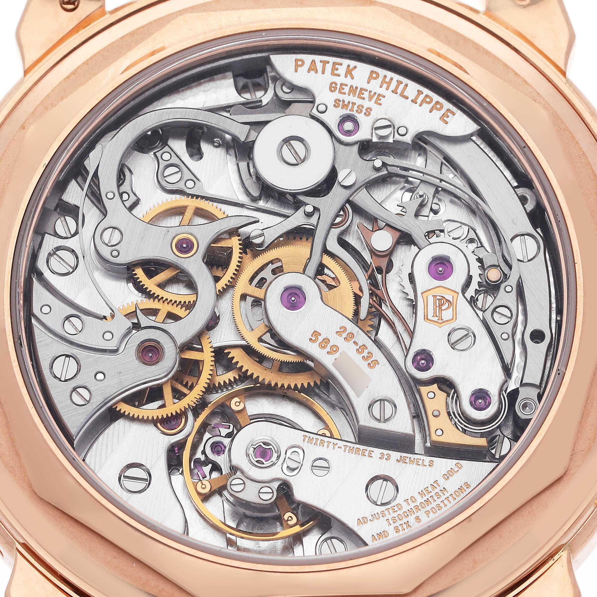 The image shows the back view of the Patek Philippe Complications 5270R-001 Men's Rose Gold Silver Dial 5270R-001 Men's Rose Gold Silver Dial model, highlighting its intricate movement and gears.