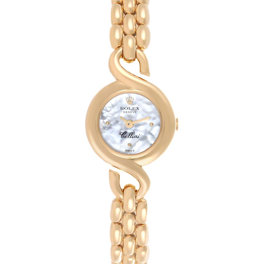 The Rolex Cellini watch is shown from the front, highlighting its round face and elegant gold bracelet.