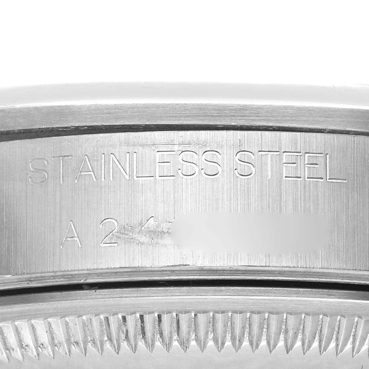 The image shows the side engraving on the case of a Rolex Date 15200 Men's Stainless Steel Pink Dial 15200 Men's Stainless Steel Pink Dial model, highlighting "STAINLESS STEEL".