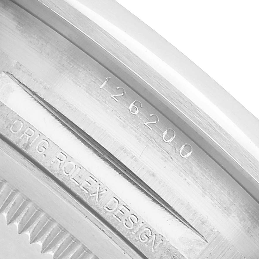 The image shows the engraved inner bezel of a Rolex Datejust 126200 Men's Stainless Steel Blue Dial watch, displaying the model number and "ORIG ROLEX DESIGN".