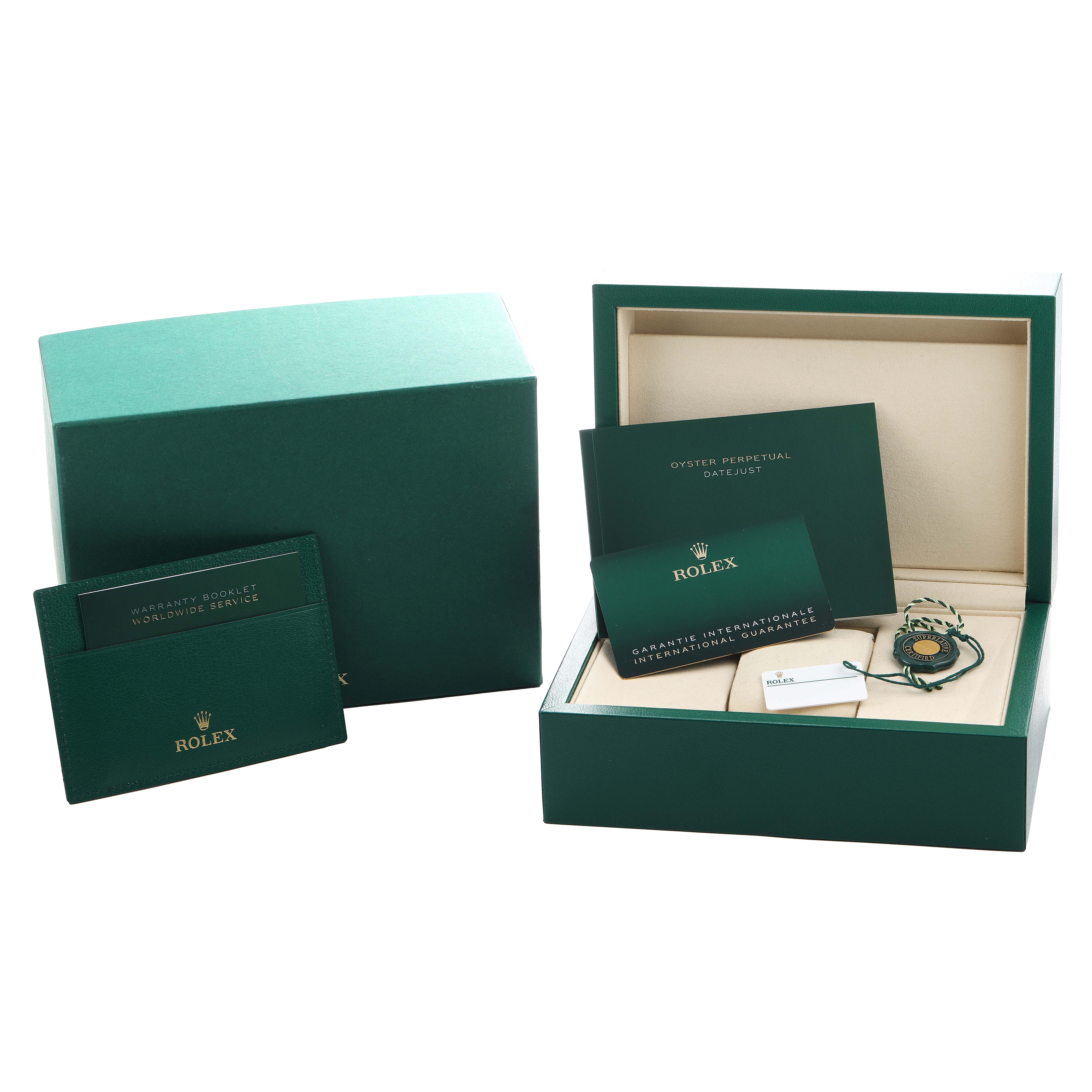 The image shows the packaging and accessories of a Rolex Datejust 126200 Men's Stainless Steel Blue Dial, including a box, booklets, and tags.