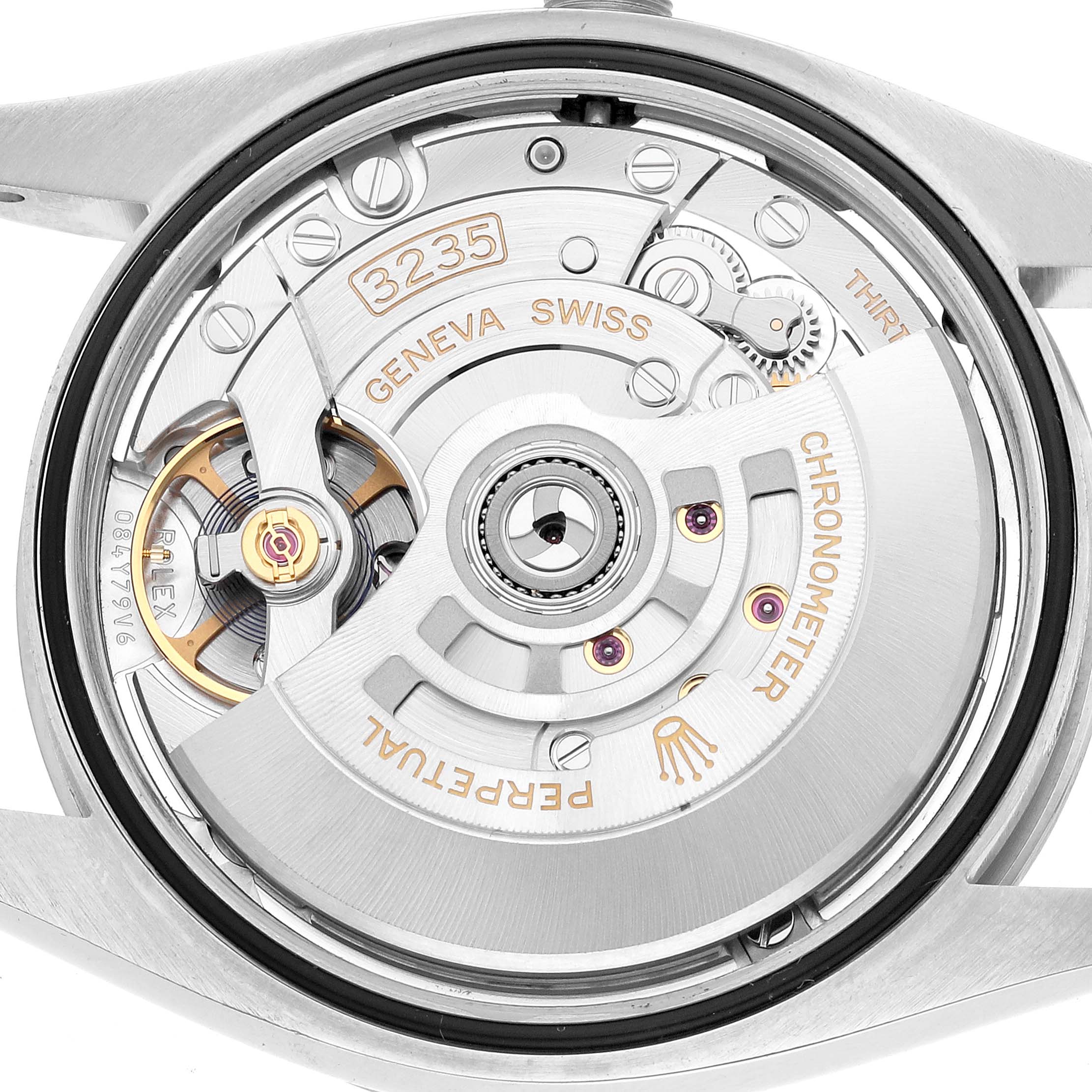 The image shows the internal mechanism of a Rolex Datejust 126200 Men's Stainless Steel Blue Dial, focusing on the movement and rotor from a rear angle.