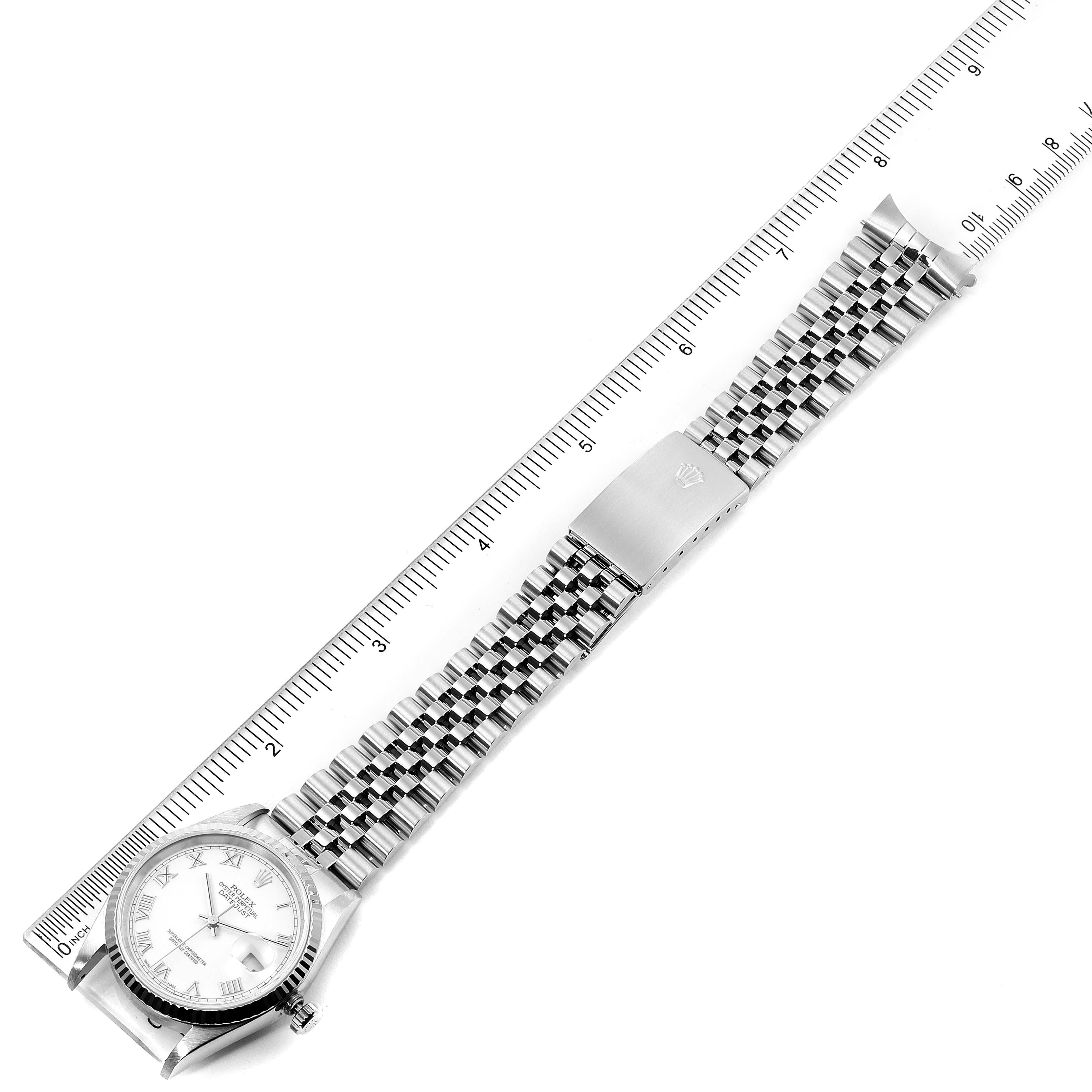 This image shows a full view of the Rolex Datejust 16234 Men's Stainless Steel White Dial 16234 Men's Stainless Steel White Dial watch laying flat with a ruler beside it for scale.