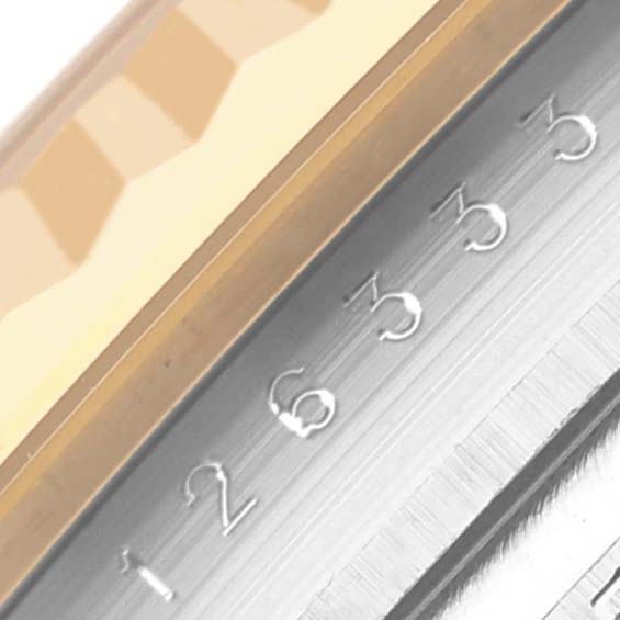 The image shows a close-up side view of the bezel and date wheel on a Rolex Datejust 41 126333 Men
s Steel and Gold (two tone) Black Dial 126333 Men
s Steel and Gold (two tone) Black Dial.