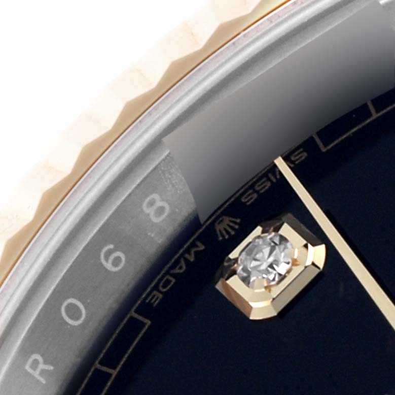 The image shows a close-up of the Rolex Datejust 41 126333 Men
s Steel and Gold (two tone) Black Dial 126333 Men
s Steel and Gold (two tone) Black Dial watch, highlighting the bezel, dial edge, and diamond hour marker.
