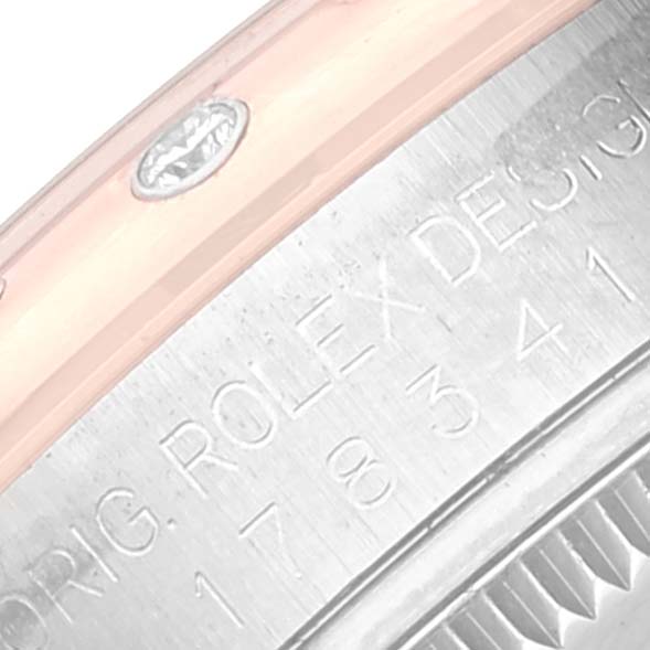 This close-up image of a mid-size Rolex watch shows the side engraving of the stainless steel case with model details.