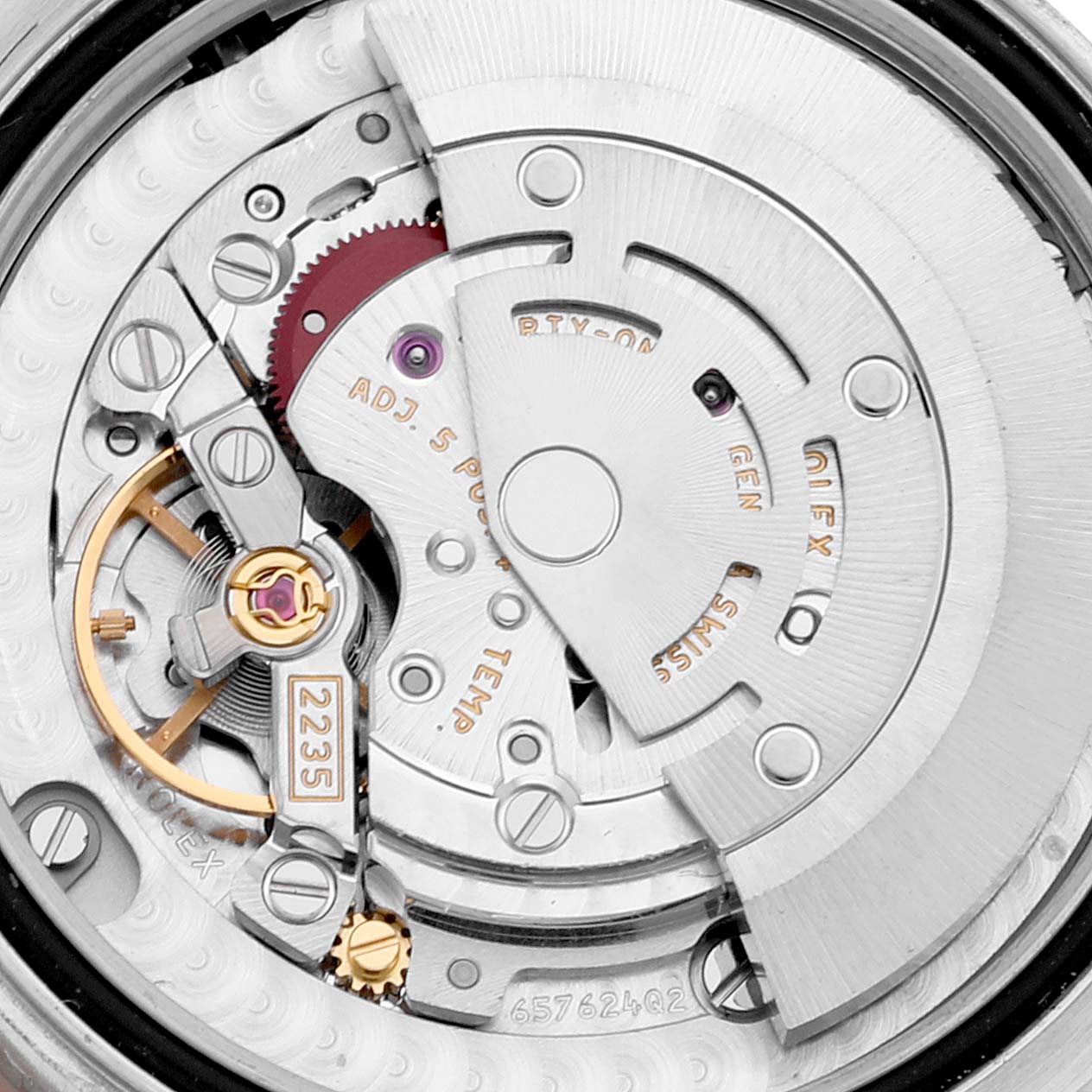 The image shows the intricate mechanism and movement of a Mid-Size Rolex watch from the back angle.