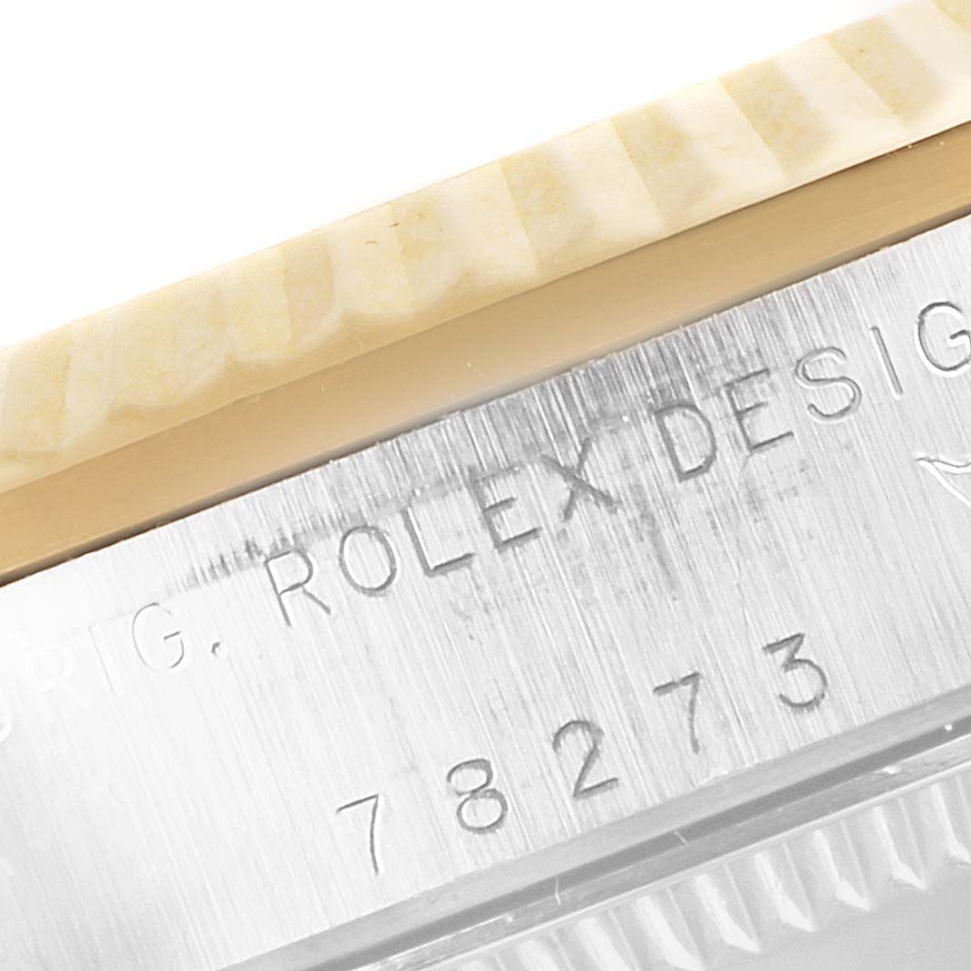 The image shows a close-up of the case side, bezel, and part of the serial number of a mid-size Rolex watch.