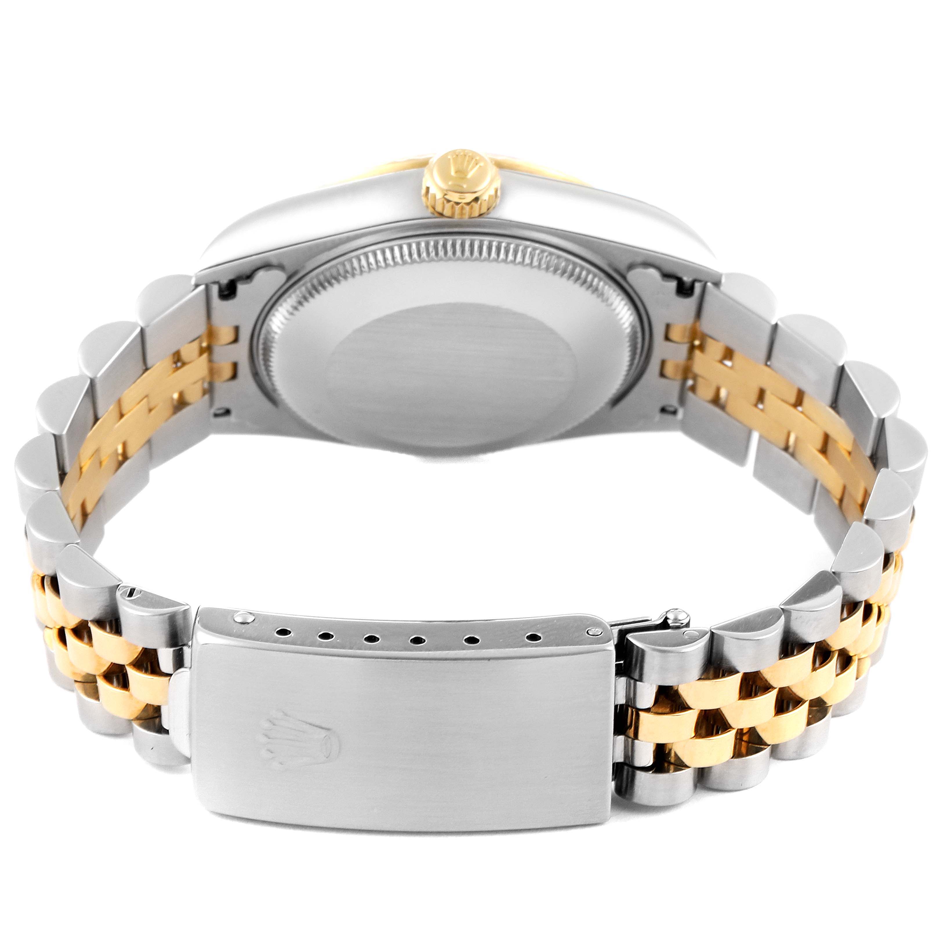 The image shows the back case, crown, and two-tone bracelet of a Rolex Mid-Size 78273 Women
s Steel and Gold (two tone) Silver Dial 78273 Women
s Steel and Gold (two tone) Silver Dial watch from a rear angle.