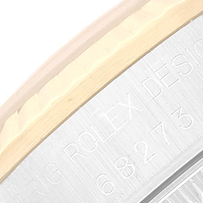 This image shows a close-up of the engraved casing edge on a Rolex Mid-Size 68273 Women
s Steel and Gold (two tone) Champagne Dial 68273 Women
s Steel and Gold (two tone) Champagne Dial model watch.