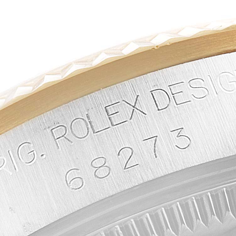 This image shows a close-up of the side engraving on a Mid-Size Rolex watch, detailing the model number and part of the bezel.