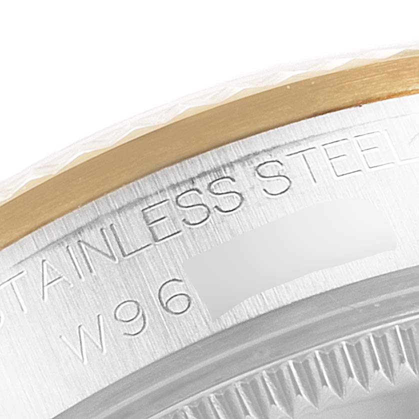 This is a close-up view of the stainless steel and gold bezel of a Rolex Mid-Size 68273 Women's Steel and Gold (two tone) Mother of Pearl Dial 68273 Women's Steel and Gold (two tone) Mother of Pearl Dial model watch.