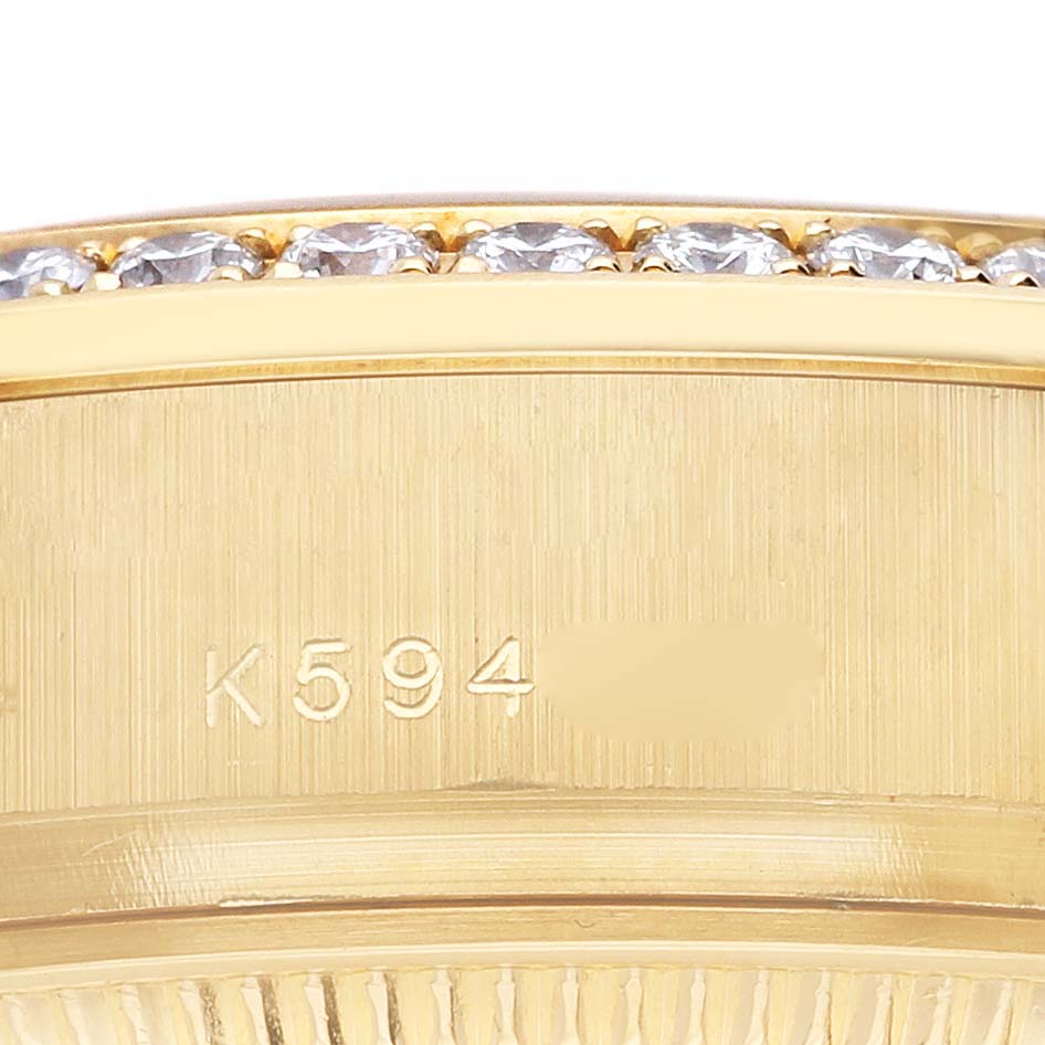 The image shows a detailed close-up of the gold side of the Rolex President 179138 Women's Yellow Gold Champagne Dial 179138 Women's Yellow Gold Champagne Dial watch, highlighting its bezel with diamonds and part of the serial number.