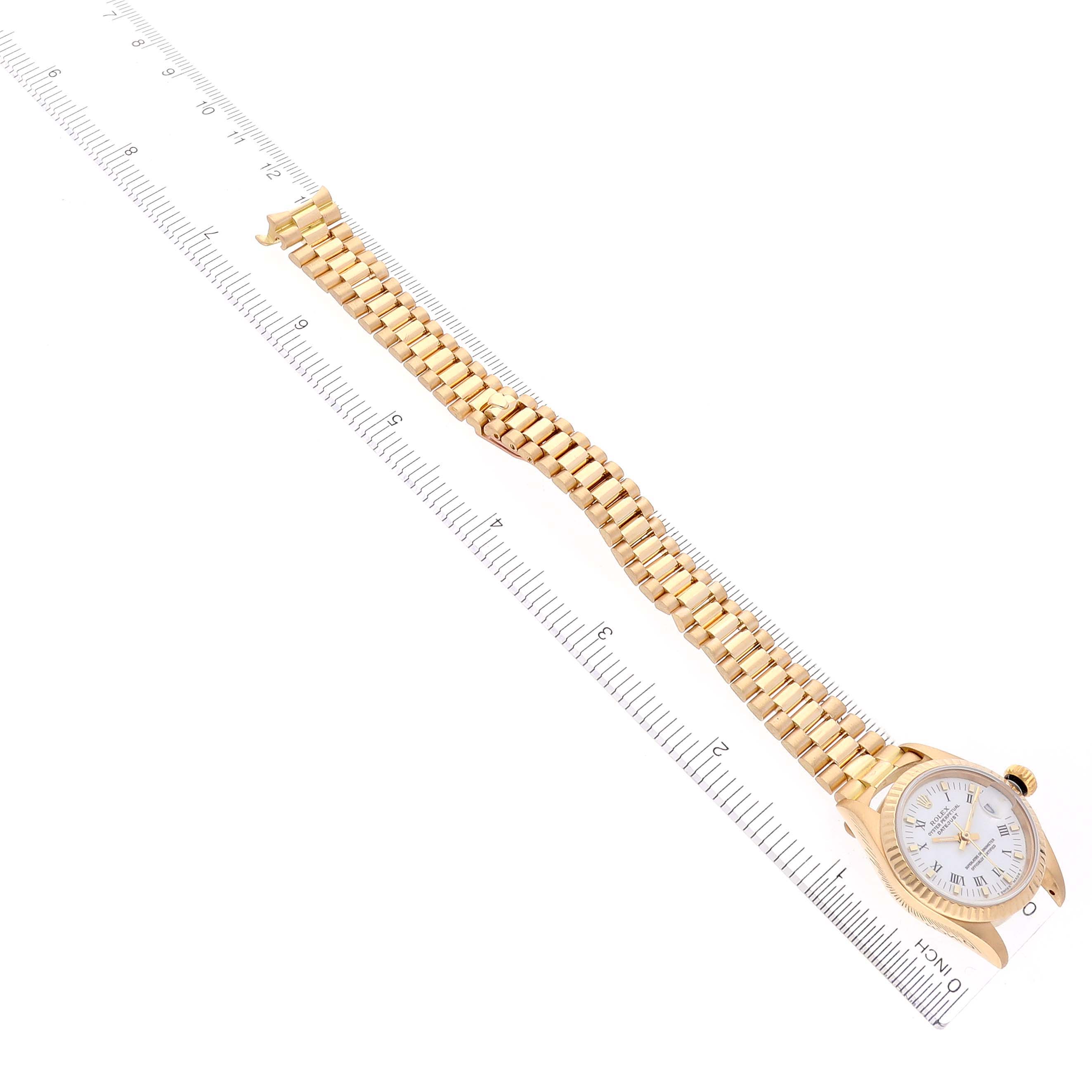 The Rolex President 69178 Women's Yellow Gold White Dial 69178 Women's Yellow Gold White Dial watch is shown flat, displaying the entire bracelet and face, alongside a ruler for scale.