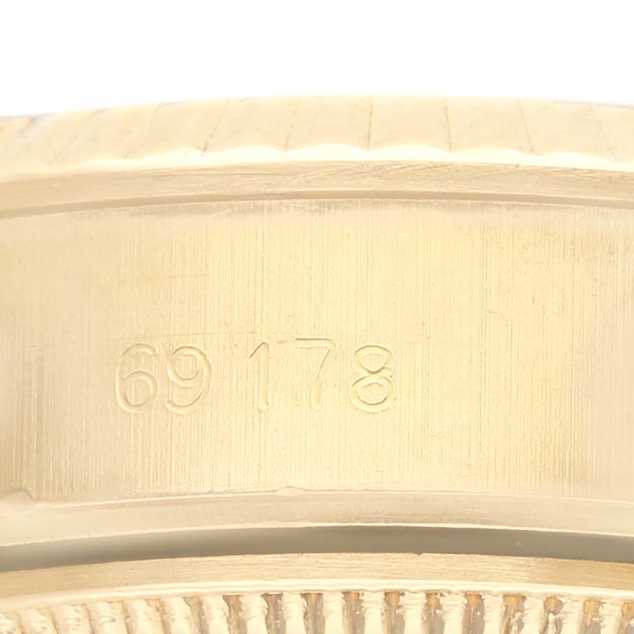 The image shows the side of a Rolex President 69178 Women's Yellow Gold White Dial 69178 Women's Yellow Gold White Dial watch model 69178, focusing on the case and engraved reference number.