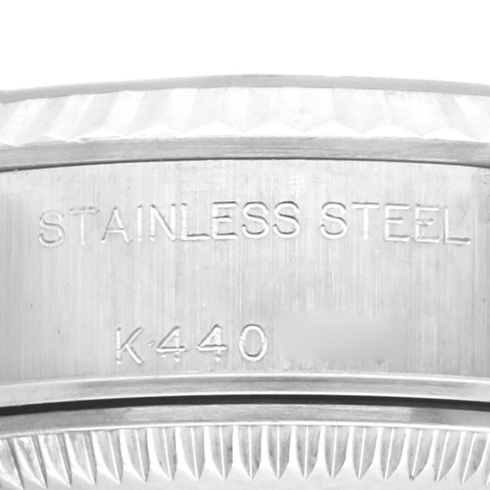 The image shows a close-up of the side of the Rolex Datejust 79174 Women's Stainless Steel Pink Dial 79174 Women's Stainless Steel Pink Dial, focusing on the stainless steel case with engravings.