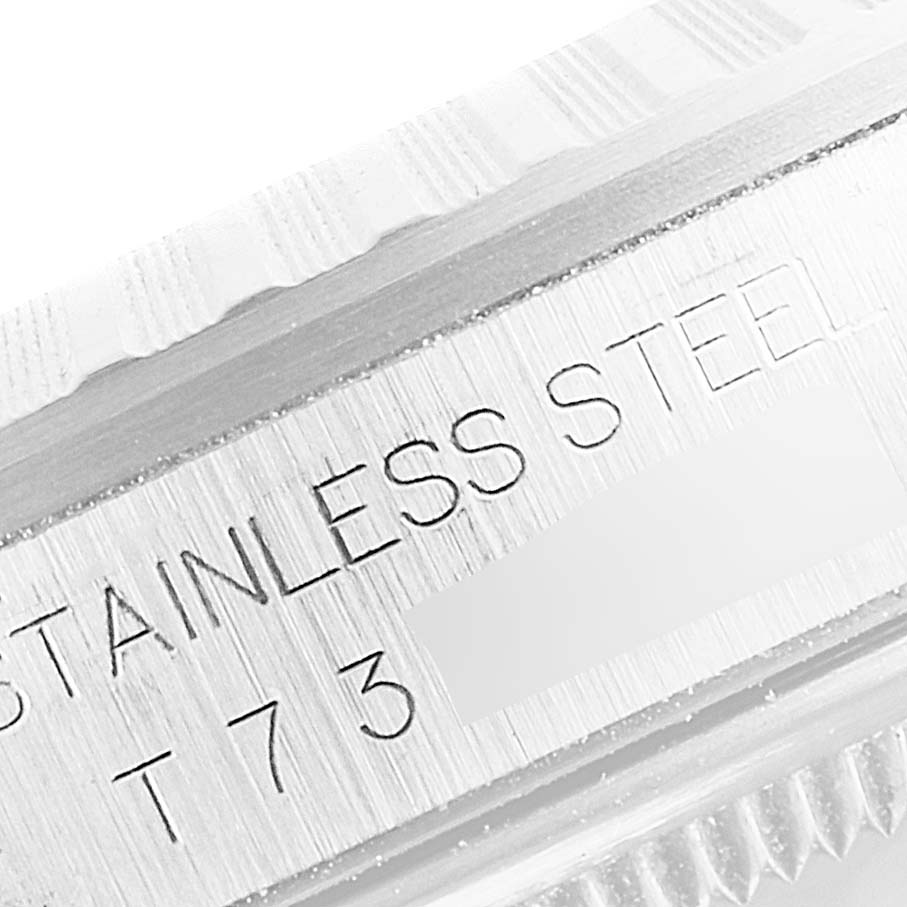 This close-up shot shows the engraved "STAINLESS STEEL" text on the case of a Rolex Datejust 16220 Men's Stainless Steel Silver Dial 16220 Men's Stainless Steel Silver Dial watch.