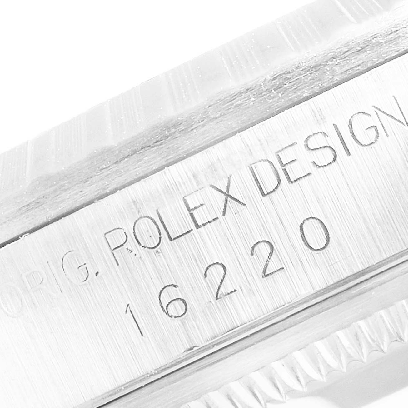 The image shows a close-up of the case side of a Rolex Datejust 16220 Men's Stainless Steel Silver Dial 16220 Men's Stainless Steel Silver Dial, featuring the model number 16220 and text "ORIG. ROLEX DESIGN."