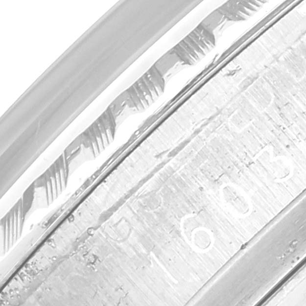 This close-up image shows the engraved details on the bezel and case of a Rolex Vintage Collection 1603 Men's Stainless Steel Silver Dial 1603 Men's Stainless Steel Silver Dial model watch.