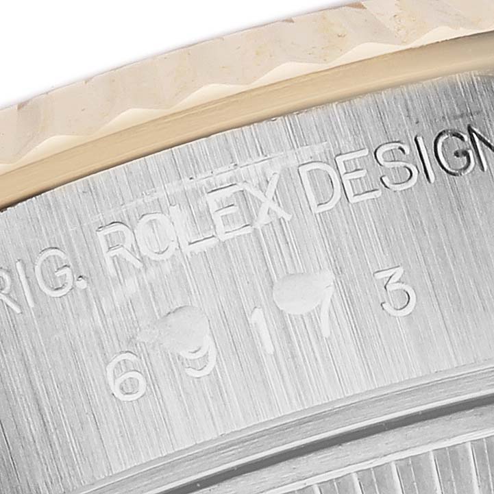 The image shows a close-up of the Rolex Datejust 69173 Women
s Steel and Gold (two tone) Silver Dial 69173 Women
s Steel and Gold (two tone) Silver Dial
s engraved case side highlighting text and numbers.