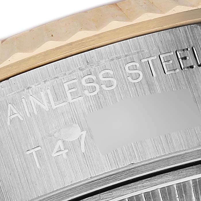 The close-up image shows the edge of the bezel and engravings on the stainless steel case back of the Rolex Datejust 69173 Women
s Steel and Gold (two tone) Silver Dial 69173 Women
s Steel and Gold (two tone) Silver Dial.