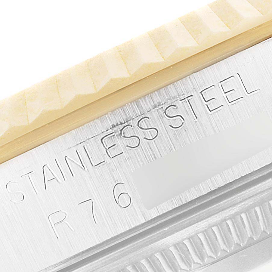 This close-up image shows the side view of the bezel and case with engravings on a Rolex Datejust 16233 Men's Steel and Gold (two tone) Champagne Dial 16233 Men's Steel and Gold (two tone) Champagne Dial watch.