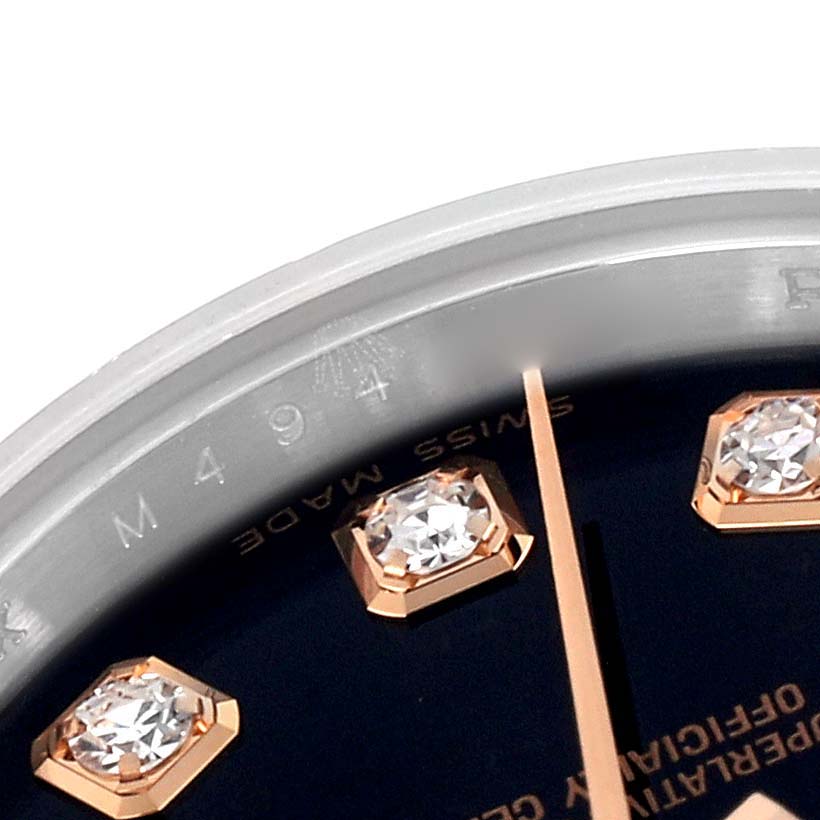 The image shows a close-up of the Rolex Datejust 179171 Women's Steel and Gold (two tone) Black Dial 179171 Women's Steel and Gold (two tone) Black Dial's dial, bezel, diamond markers, and partial minute hand.