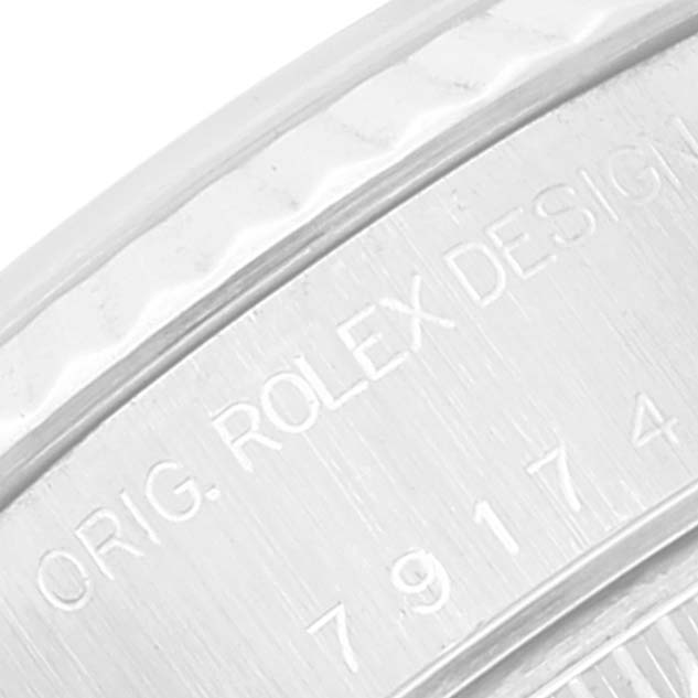 This close-up image shows part of the engraved bezel on a Rolex Datejust 79174 Women's Stainless Steel Blue Dial 79174 Women's Stainless Steel Blue Dial watch.