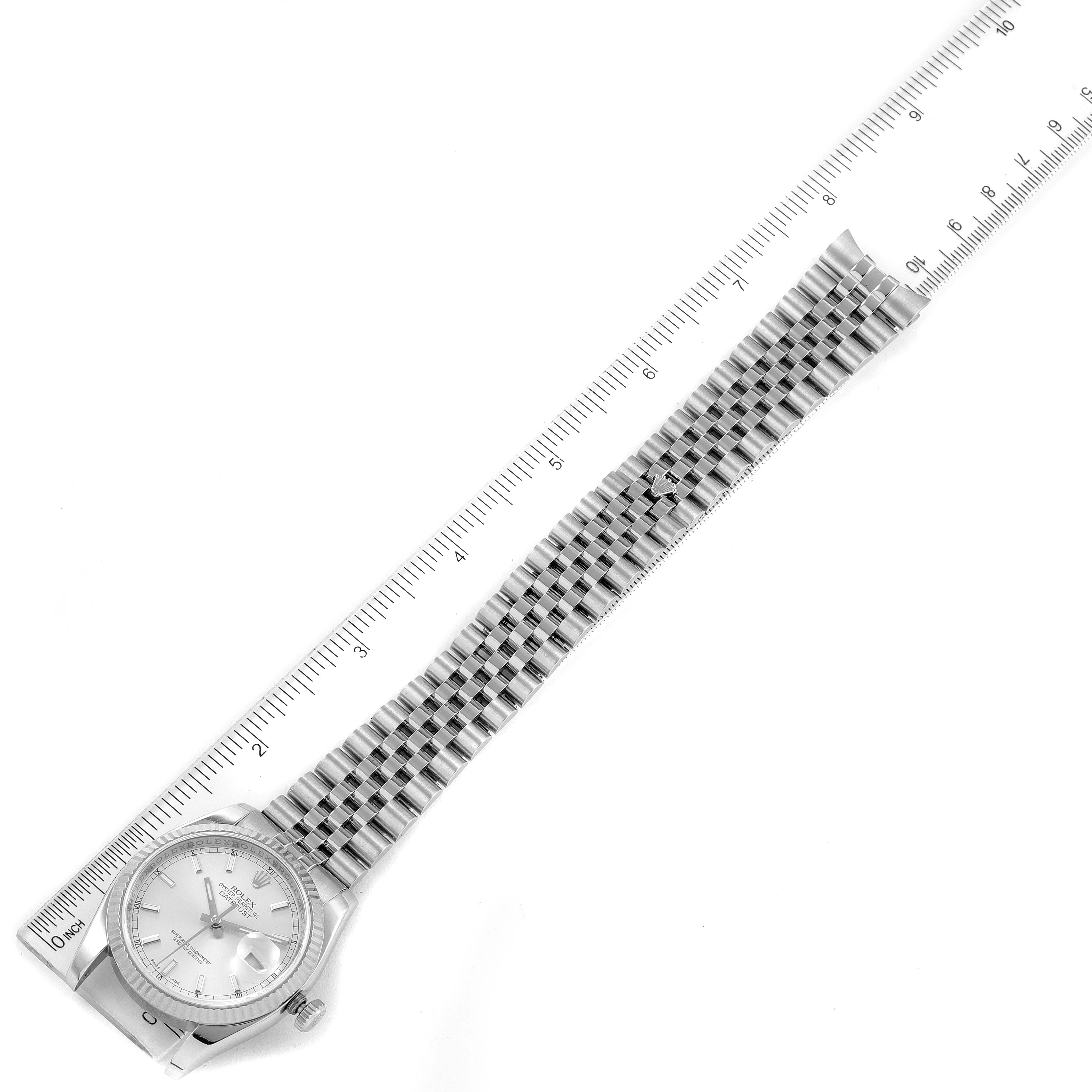 The image shows a Rolex Datejust 116234 Men's Stainless Steel Silver Dial 116234 Men's Stainless Steel Silver Dial watch laid flat, with a ruler measuring its length, revealing the watch face, bezel, and bracelet.