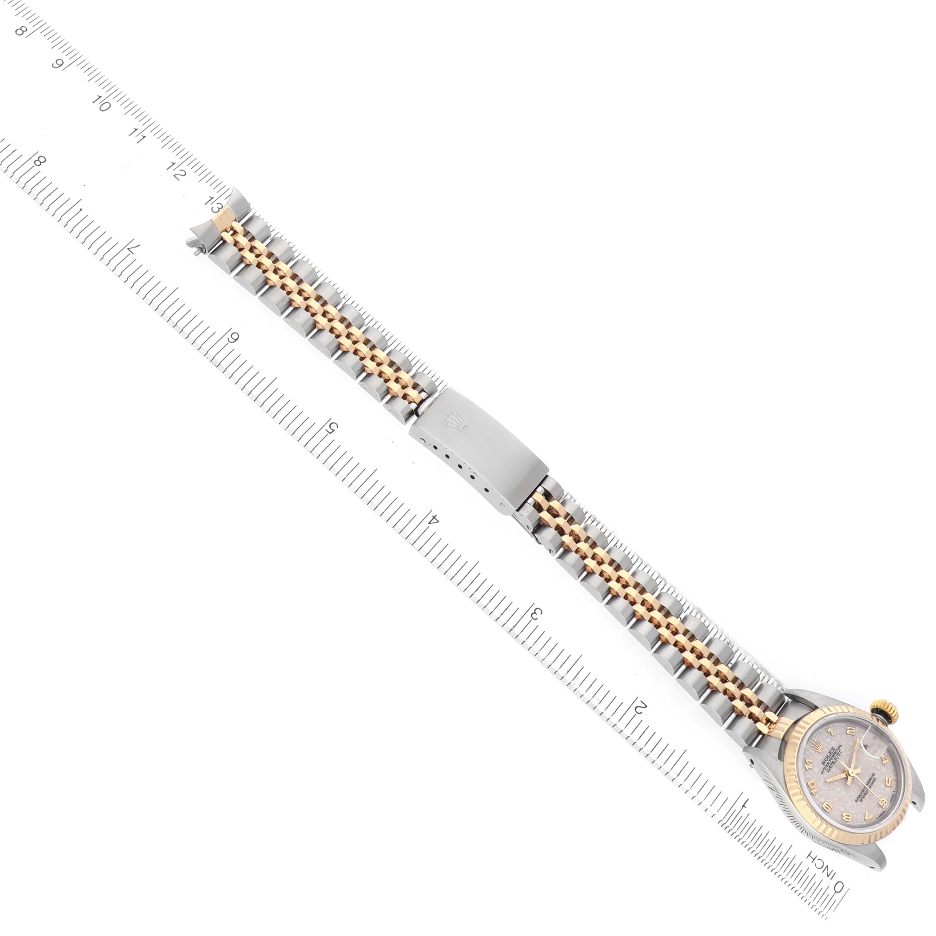 The Rolex Datejust 69173 Women's Steel and Gold (two tone) Silver Dial watch is shown flat, displaying the full bracelet, clasp, and watch face with a ruler for scale.