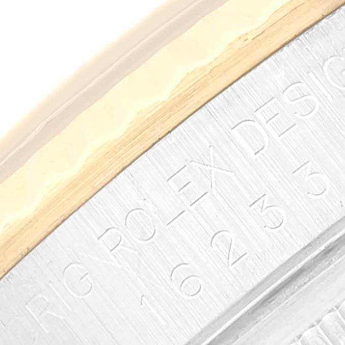 The image shows a close-up view of the engraved side of the case of a Rolex Datejust 16233 Men's Steel and Gold (two tone) Beige Dial 16233 Men's Steel and Gold (two tone) Beige Dial watch.
