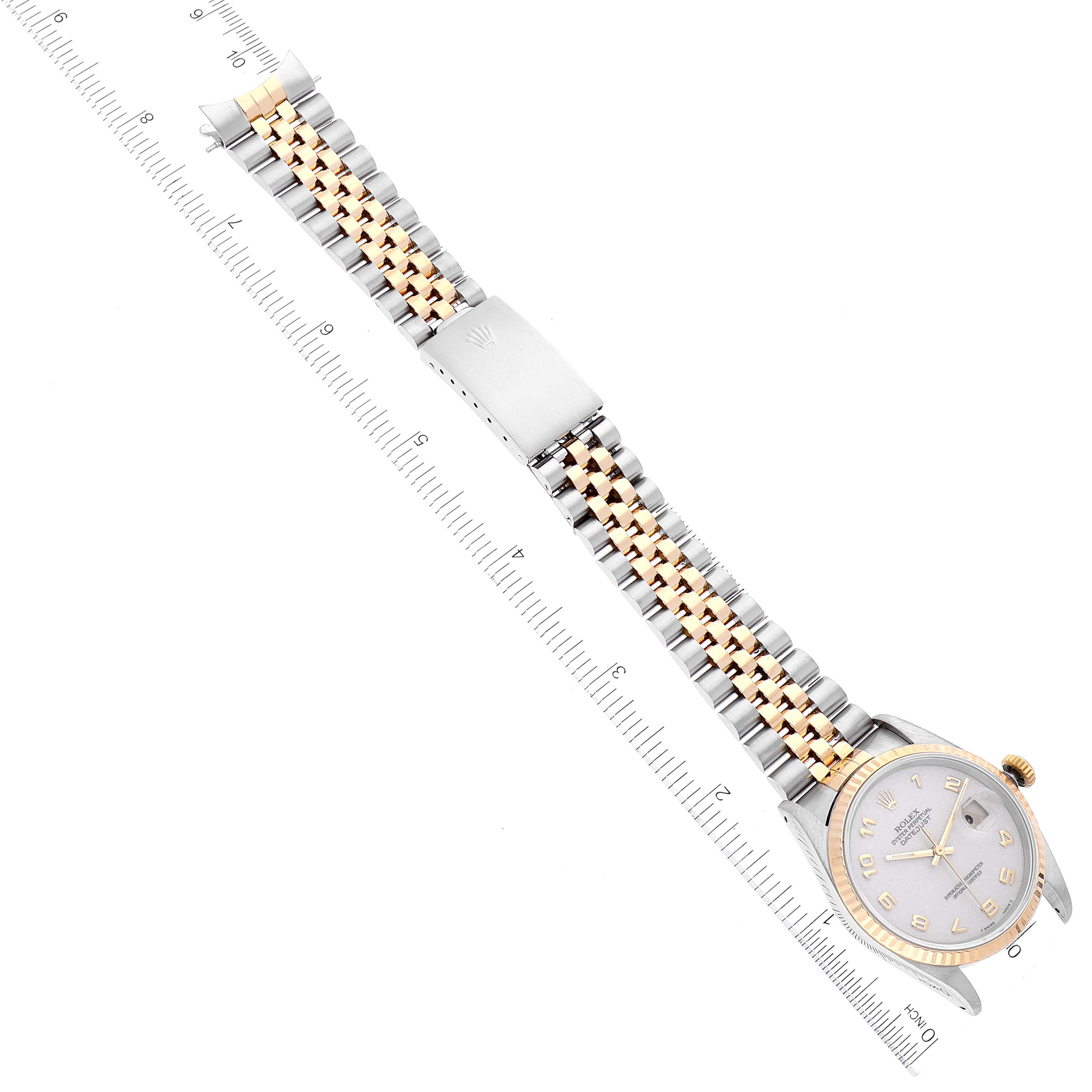 The image shows a top view of a Rolex Datejust 16233 Men's Steel and Gold (two tone) Beige Dial 16233 Men's Steel and Gold (two tone) Beige Dial watch, displaying its dial, bezel, and two-tone metal bracelet alongside a ruler.