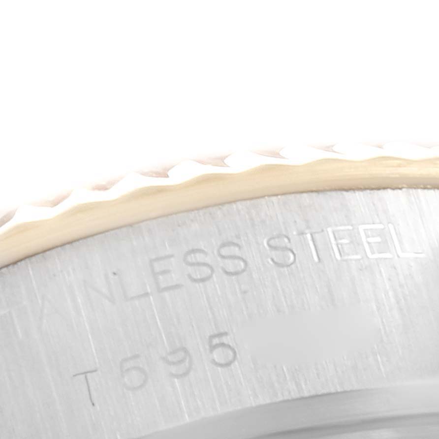 This is a close-up view of the stainless steel rim and fluted bezel of a Rolex Datejust 69173 Women's Steel and Gold (two tone) Beige Dial 69173 Women's Steel and Gold (two tone) Beige Dial watch.