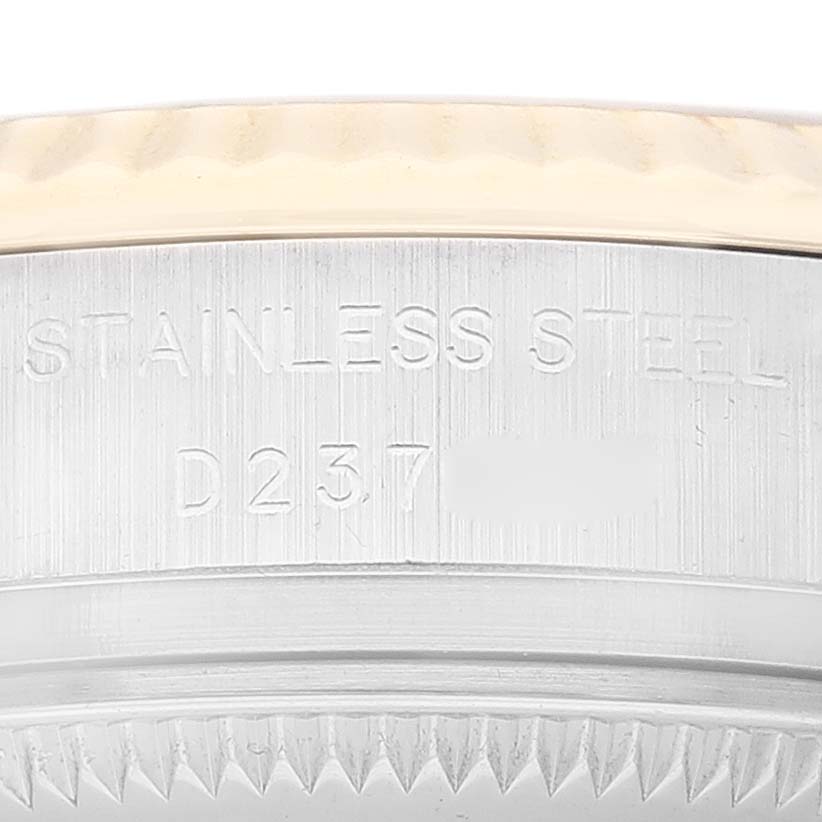 This image shows a close-up of the casing and serial number of a Rolex Datejust 179173 Women's Steel and Gold (two tone) Mother of Pearl Dial 179173 Women's Steel and Gold (two tone) Mother of Pearl Dial watch, highlighting the stainless steel material.