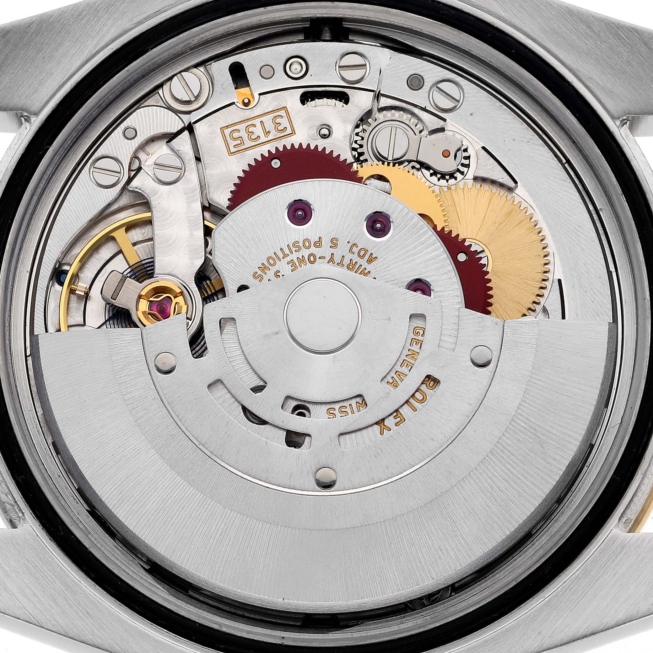 The image shows the internal movement of a Rolex Datejust 116243 Men's Steel and Gold (two tone) Mother of Pearl Dial 116243 Men's Steel and Gold (two tone) Mother of Pearl Dial watch from the back, featuring gears and rotor.