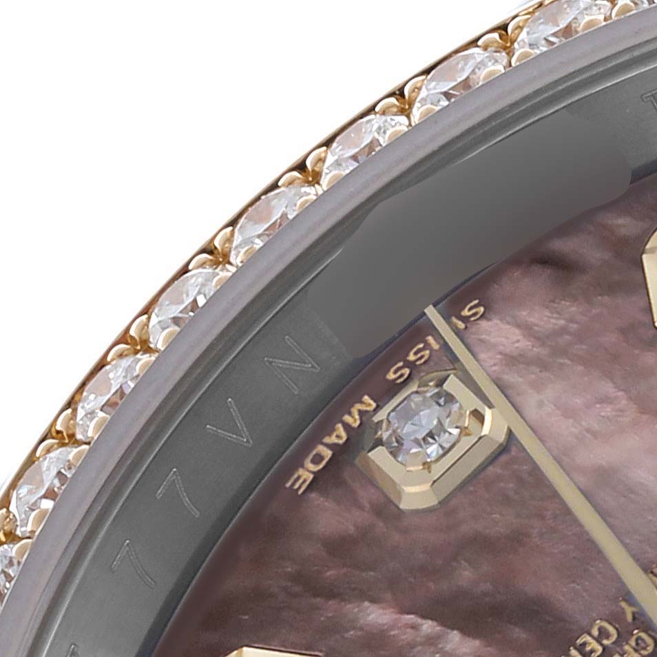 The image shows a close-up of the Rolex Datejust 116243 Men's Steel and Gold (two tone) Mother of Pearl Dial 116243 Men's Steel and Gold (two tone) Mother of Pearl Dial's diamond bezel and part of its dial with diamond hour markers.