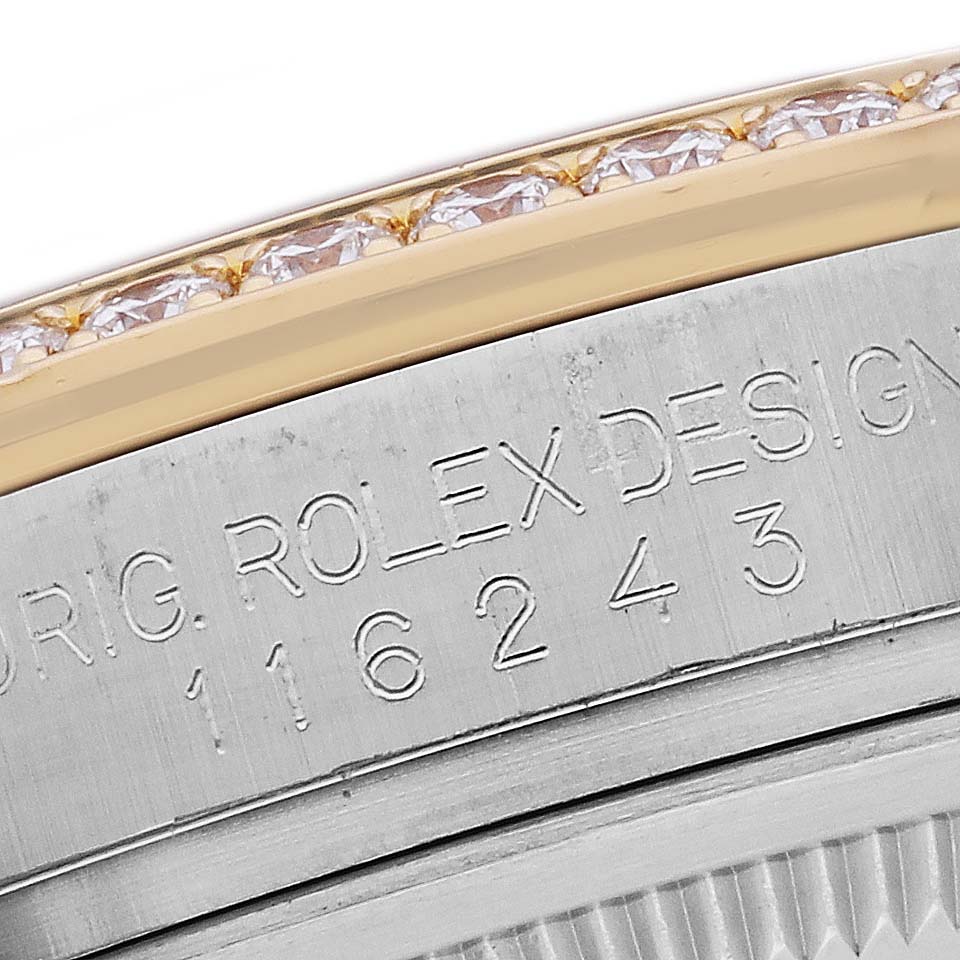 The image shows a close-up of the bezel and engraved case side of a Rolex Datejust 116243 Men's Steel and Gold (two tone) Mother of Pearl Dial 116243 Men's Steel and Gold (two tone) Mother of Pearl Dial, focusing on model number and gem detail.