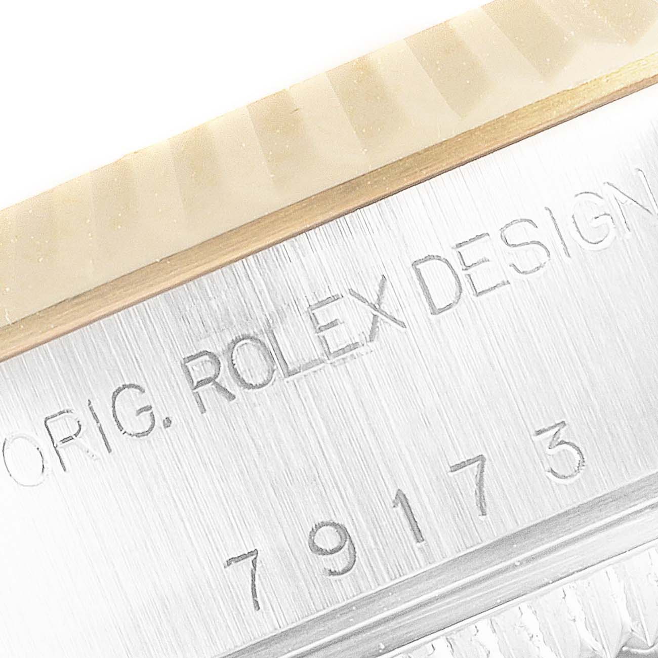 The image shows a close-up of the case with engravings on the Rolex Datejust 79173 Women's Steel and Gold (two tone) Red Dial 79173 Women's Steel and Gold (two tone) Red Dial watch, including serial numbers and text.