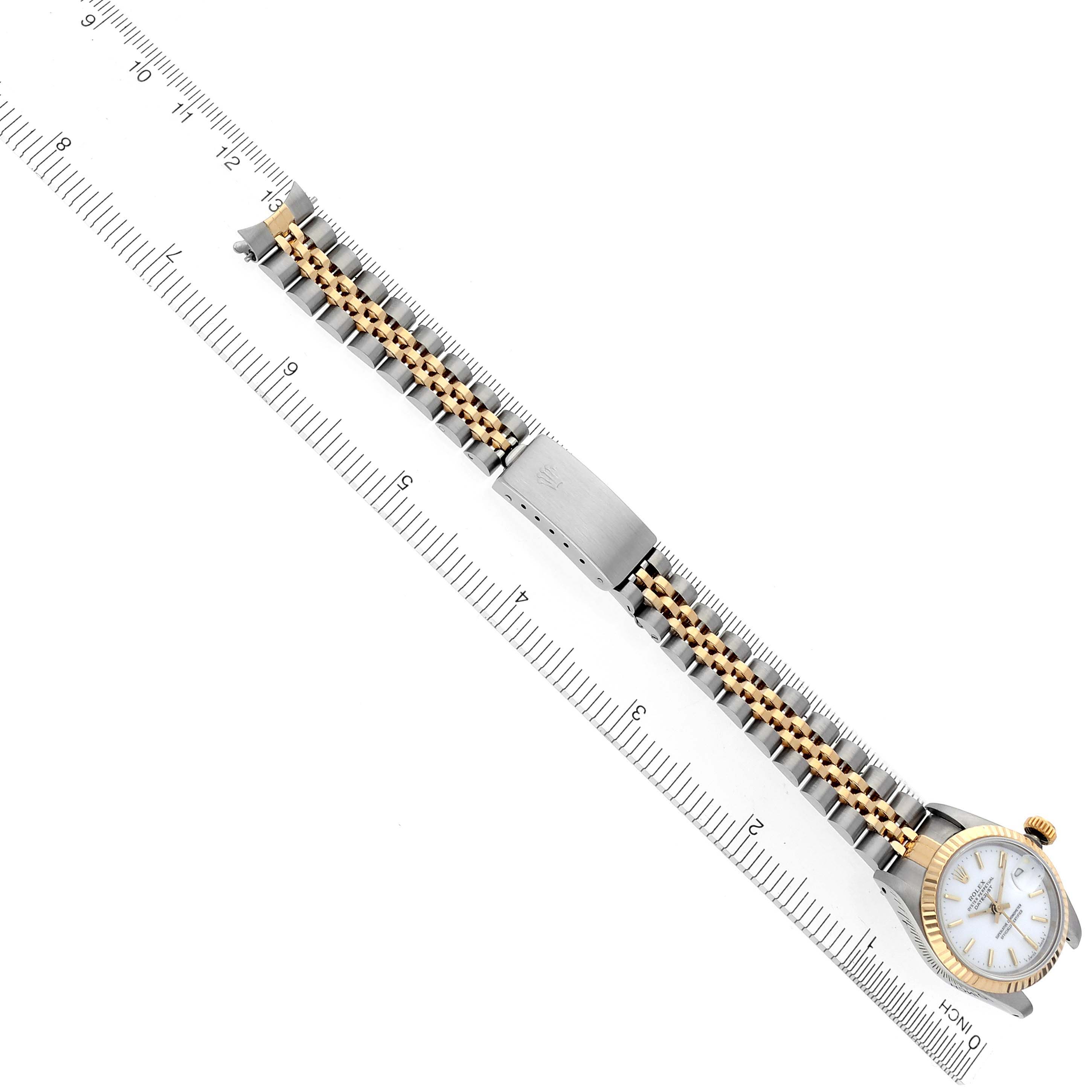 The watch is a Rolex Datejust 69173 Women's Steel and Gold (two tone) White Dial 69173 Women's Steel and Gold (two tone) White Dial, shown from above, displaying the dial and the full bracelet with a ruler for scale.