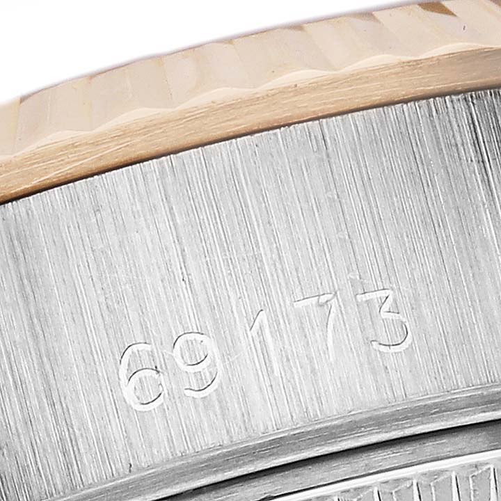 The image shows a close-up of the Rolex Datejust 69173 Women's Steel and Gold (two tone) White Dial 69173 Women's Steel and Gold (two tone) White Dial model's case side with engraved numbers.