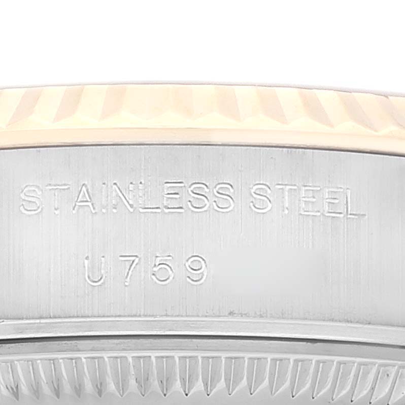 This image shows a close-up of the side of a Rolex Datejust 69173 Women's Steel and Gold (two tone) White Dial 69173 Women's Steel and Gold (two tone) White Dial watch, highlighting the "STAINLESS STEEL" engraving and part of the fluted bezel.