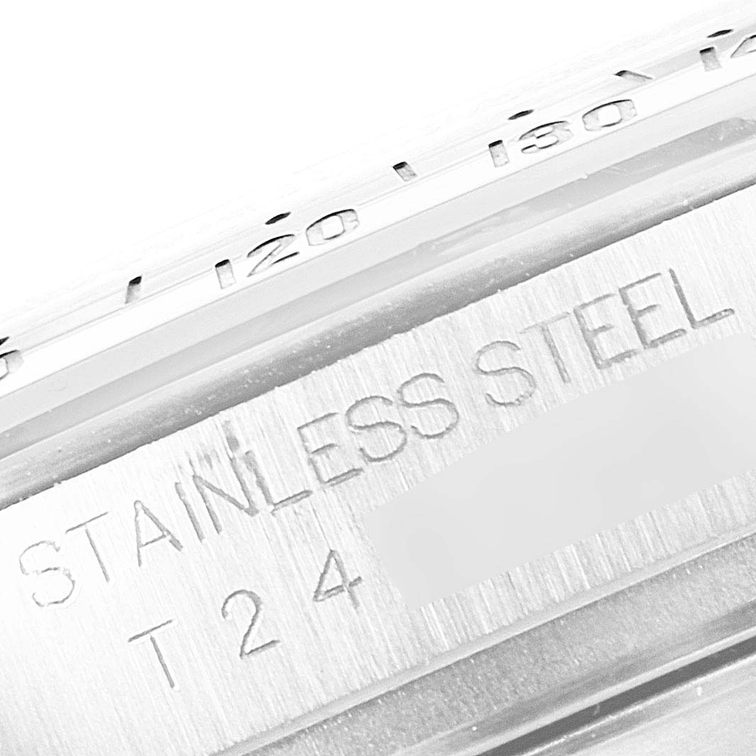 This close-up image of a Rolex Daytona 16520 Men's Stainless Steel Black Dial 16520 Men's Stainless Steel Black Dial watch shows the stainless steel material and part of the engraved bezel with numerical markings.