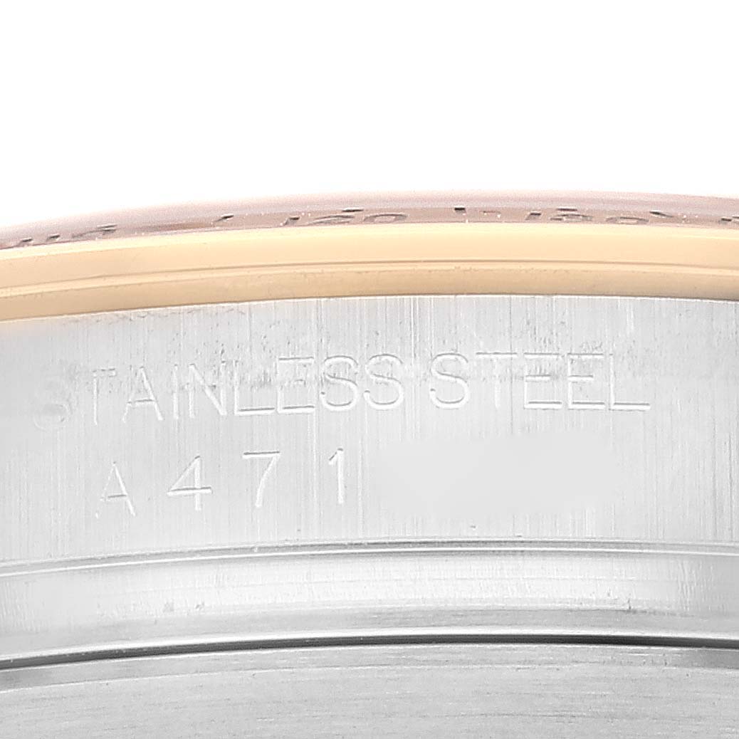 The image shows a close-up view of the case engraving on a Rolex Daytona 16523 Men's Steel and Gold (two tone) White Dial 16523 Men's Steel and Gold (two tone) White Dial watch, highlighting "STAINLESS STEEL" and the model number.