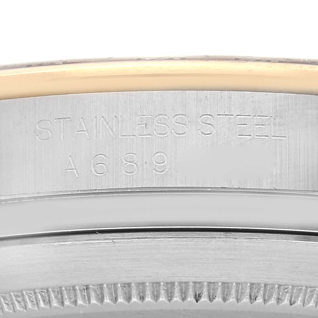 This close-up image shows the case and part of the engraved serial number of a Rolex Daytona 16523G Men
s Steel and Gold (two tone) Black Dial 16523G Men
s Steel and Gold (two tone) Black Dial model watch.