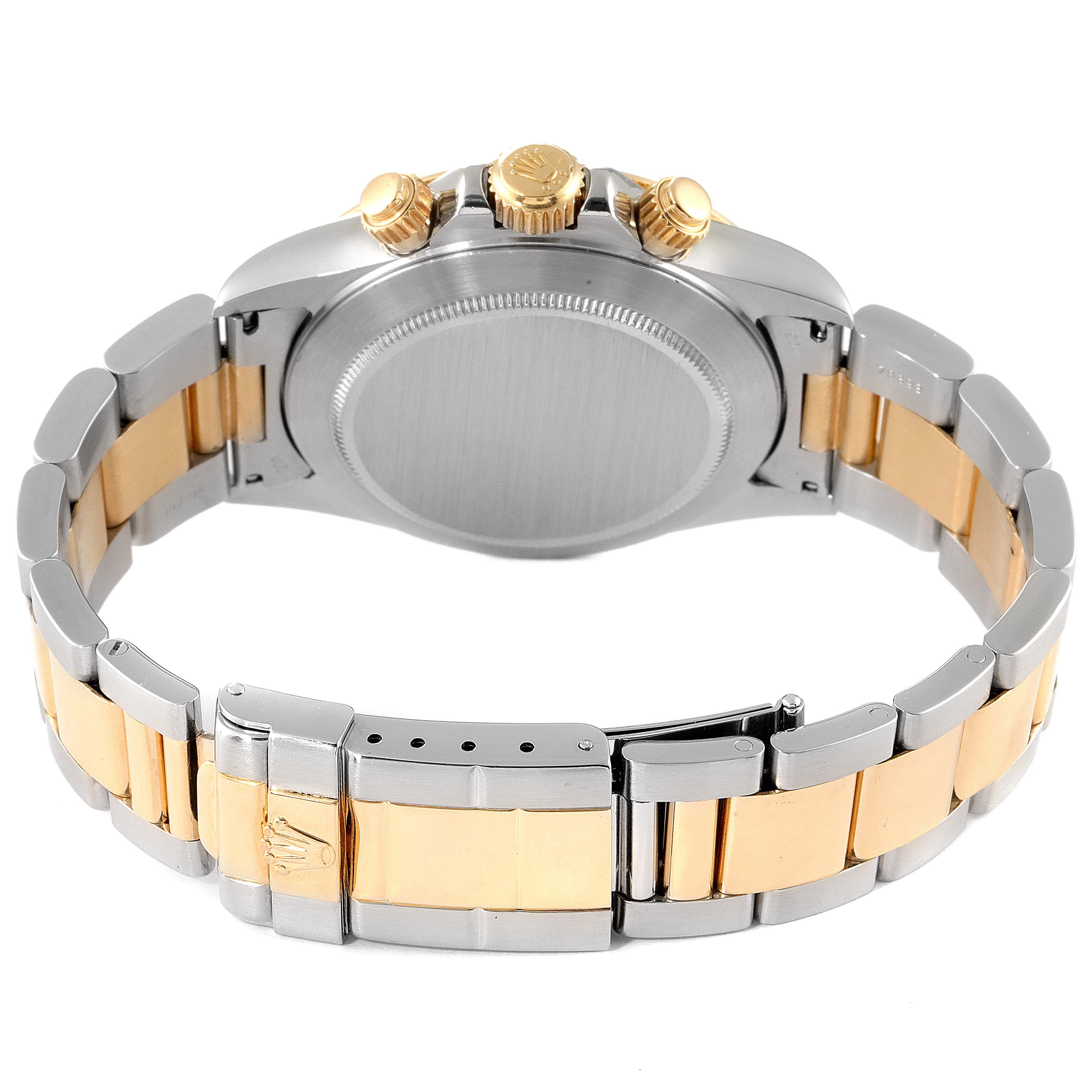 The image shows the back and clasp of a Rolex Daytona 16523 Men
s Steel and Gold (two tone) White Dial 16523 Men
s Steel and Gold (two tone) White Dial watch, highlighting its two-tone bracelet and crown with pushers.