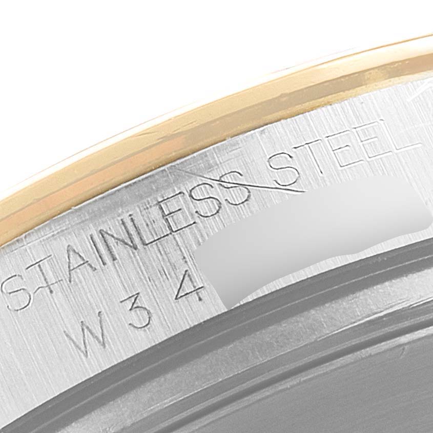This image shows a close-up of the stainless steel case back engraved with "STAINLESS STEEL" on the Rolex Daytona 16523 Men
s Steel and Gold (two tone) White Dial 16523 Men
s Steel and Gold (two tone) White Dial model.