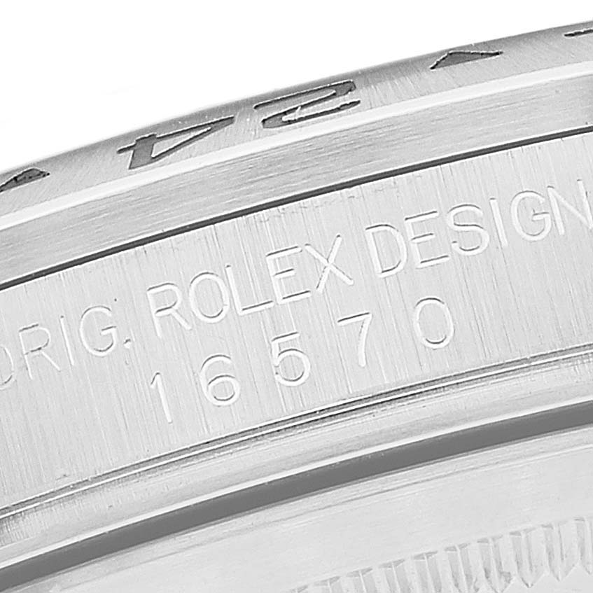This close-up image of the Rolex Explorer 16570 Men
s Stainless Steel Black Dial 16570 Men
s Stainless Steel Black Dial watch shows the etched serial number and brand details on the watch case.