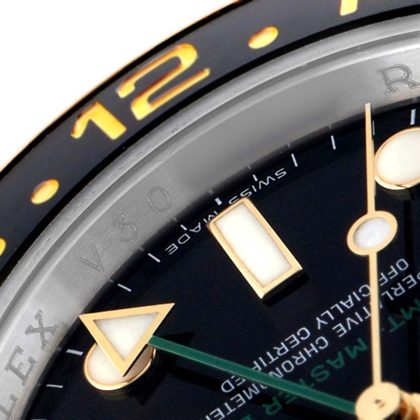 The image shows a close-up of the Rolex GMT-Master 116713 Men's Steel and Gold (two tone) Black Dial's dial, focusing on the hour markers, hands, and part of the bezel.