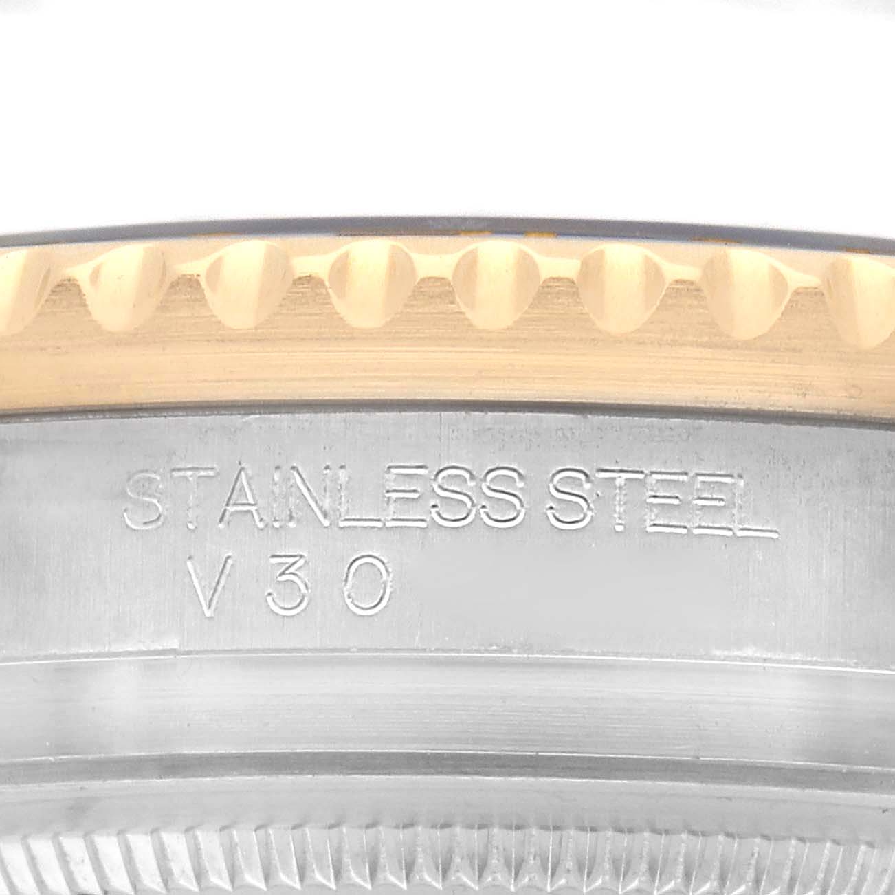 The image shows a close-up of the side of a Rolex GMT-Master 116713 Men's Steel and Gold (two tone) Black Dial watch, focusing on the stainless steel and gold bezel.